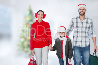 Composite image of happy family looking at camera