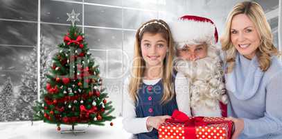 Composite image of mother and daughter with santa claus