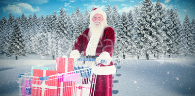 Composite image of santa pushes a shopping cart with presents