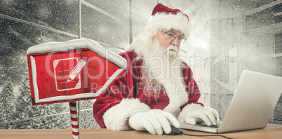 Composite image of santa surfs on the internet