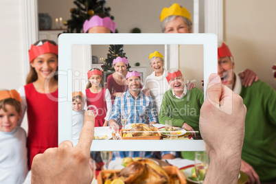 Composite image of hand holding tablet pc