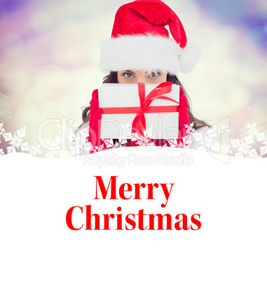 Composite image of brunette in red gloves and santa hat showing