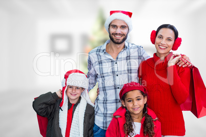 Composite image of happy family looking at camera