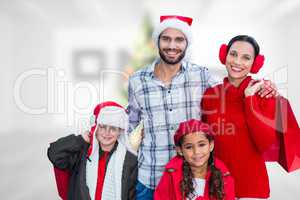 Composite image of happy family looking at camera