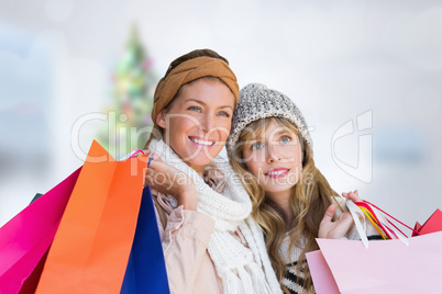 Composite image of smiling women looking at camera with shopping