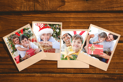 Composite image of surprised little daughter opening a christmas present with her father