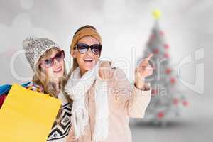 Composite image of beautiful women holding shopping bags pointin
