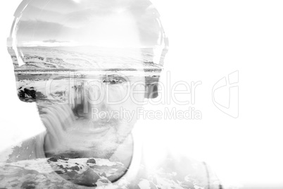 Young man with headphones and waterfall, double exposure