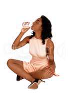 African American woman drinking water.