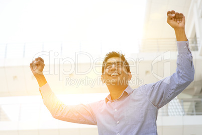 Asian Indian businessman arms up