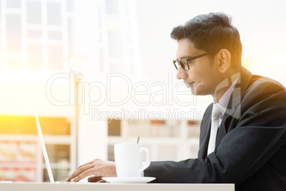 Business man browsing internet at cafe