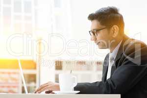 Business man browsing internet at cafe