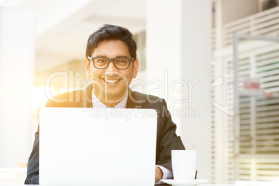 Business man using laptop computer at cafe