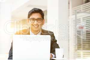 Business man using laptop computer at cafe