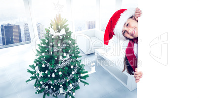 Composite image of festive little girl showing card