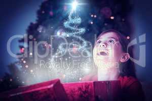 Composite image of little girl opening a magical christmas gift