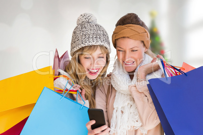 Composite image of smiling women with shopping bags looking at m