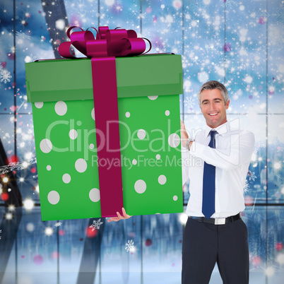 Composite image of stylish man with giant gift