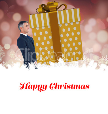 Composite image of stylish man with giant gift