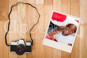 Composite image of mother kissing her daughter at christmas