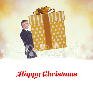 Composite image of stylish man with giant gift