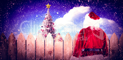 Composite image of santa carrying sack of gifts