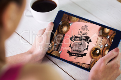 Composite image of woman using tablet pc