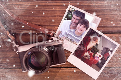 Composite image of father and son holding a christmas gift