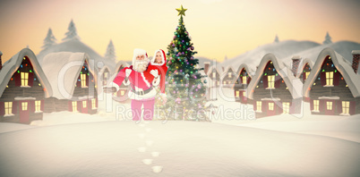 Composite image of santa and mrs claus smiling at camera