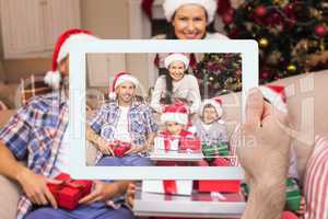 Composite image of hand holding tablet pc