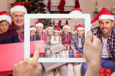 Composite image of hand holding tablet pc