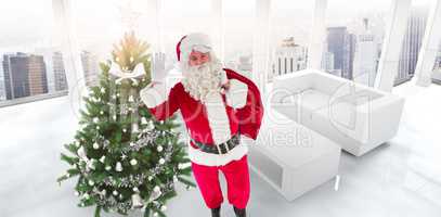 Composite image of santa holding a sack and waving