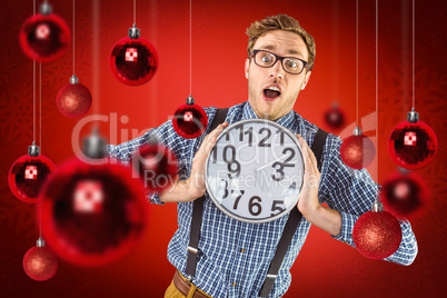 Composite image of geeky businessman holding a clock