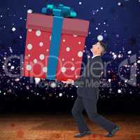 Composite image of stylish man with giant gift