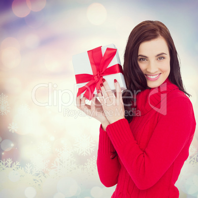 Composite image of smiling brunette in red jumper hat showing a