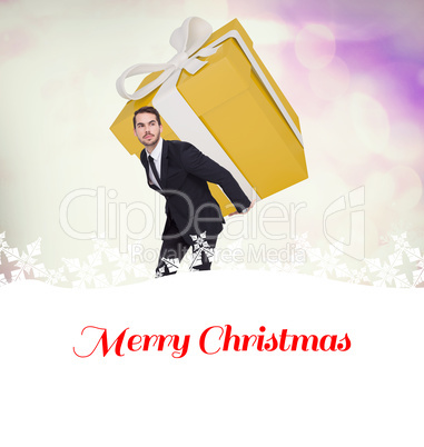 Composite image of stylish man with giant gift