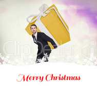 Composite image of stylish man with giant gift