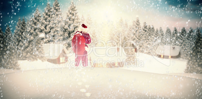 Composite image of santa carrying sack of gifts