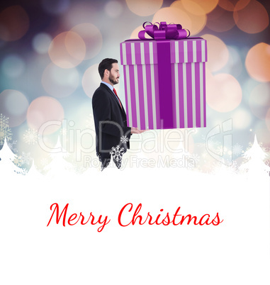 Composite image of stylish man with giant gift