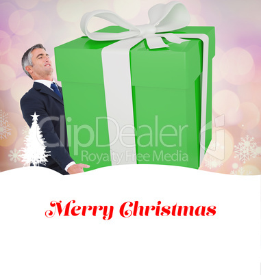 Composite image of stylish man with giant gift