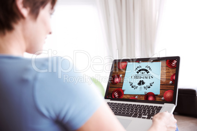 Composite image of pregnant woman using her laptop