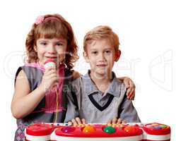 little girl and boy sing and play music