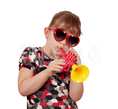 little girl with sunglasses play trumpet