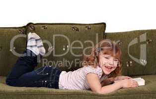 happy little girl reading a book