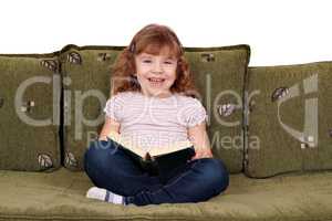 happy little girl reading a book