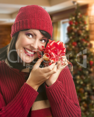 Woman Holding Wrapped Gift in Christmas Setting