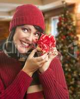 Woman Holding Wrapped Gift in Christmas Setting