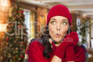 Mixed Race Woman Wearing Mittens and Hat In Christmas Setting