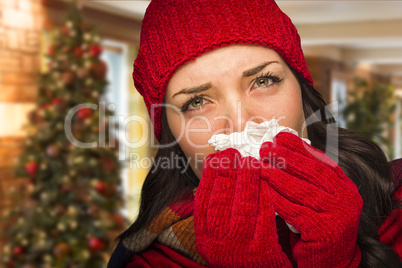 Sick Woman Blowing Her Nose With Tissue In Christmas Setting