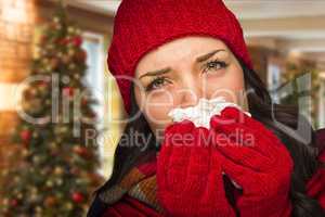 Sick Woman Blowing Her Nose With Tissue In Christmas Setting